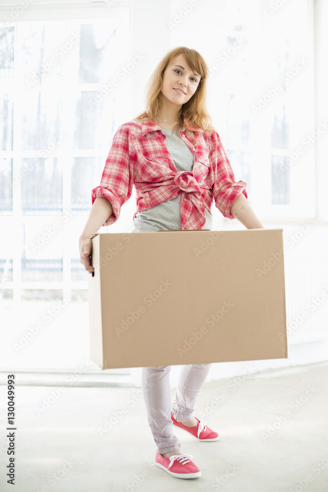 Full-length portrait of woman carrying cardboard box Full-length portrait of woman carrying cardboard box