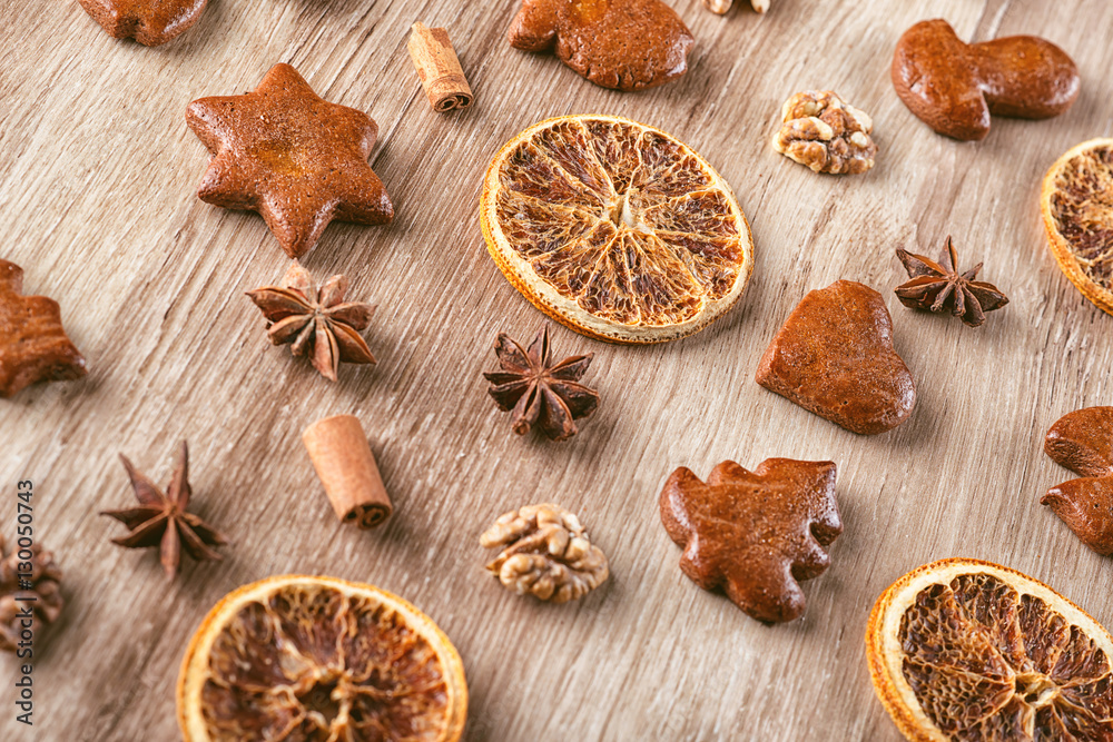 gingerbread with baking ingredients like cinnamon, orange slices and star anise on wooden background, christmas background gingerbread with baking ingredients like cinnamon, orange slices and star anise on wooden background, christmas background