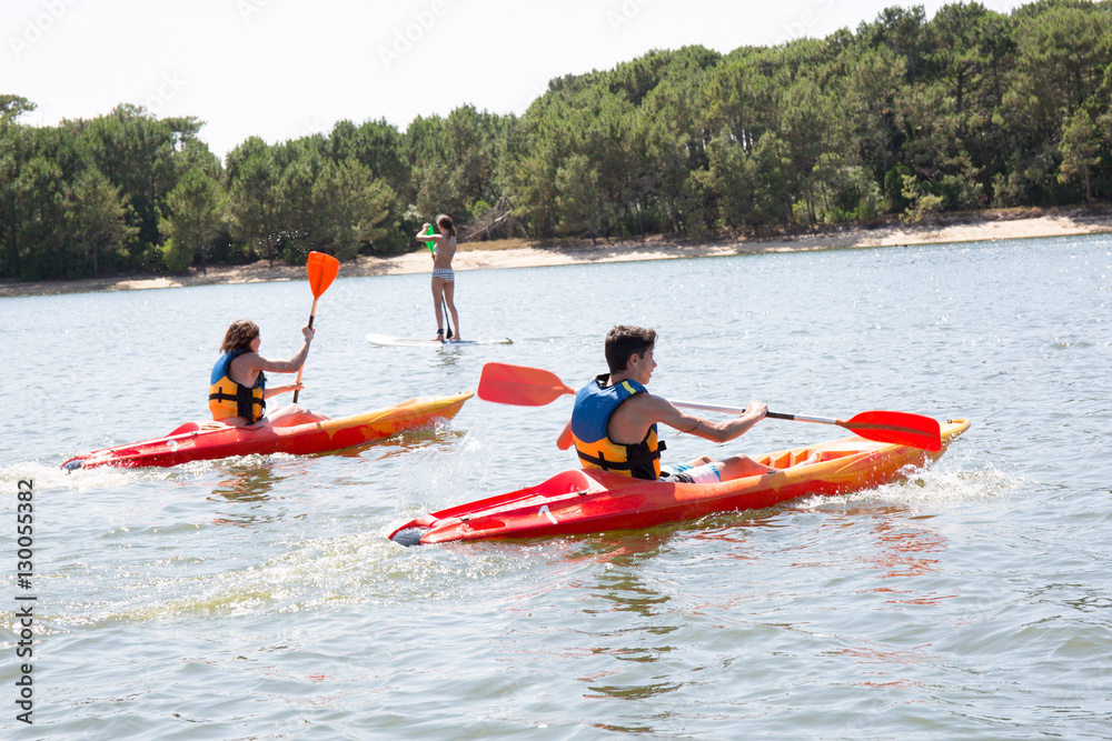 couple making a river race with kayaks