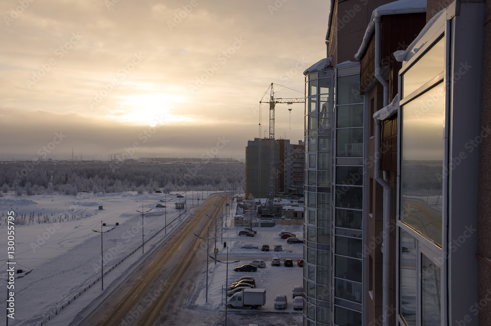 Fototapeta premium Road in the winter street. Evening, sunset