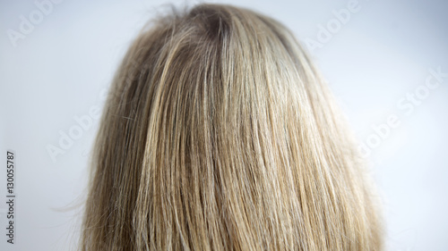 closeup of back of head with long blond hair