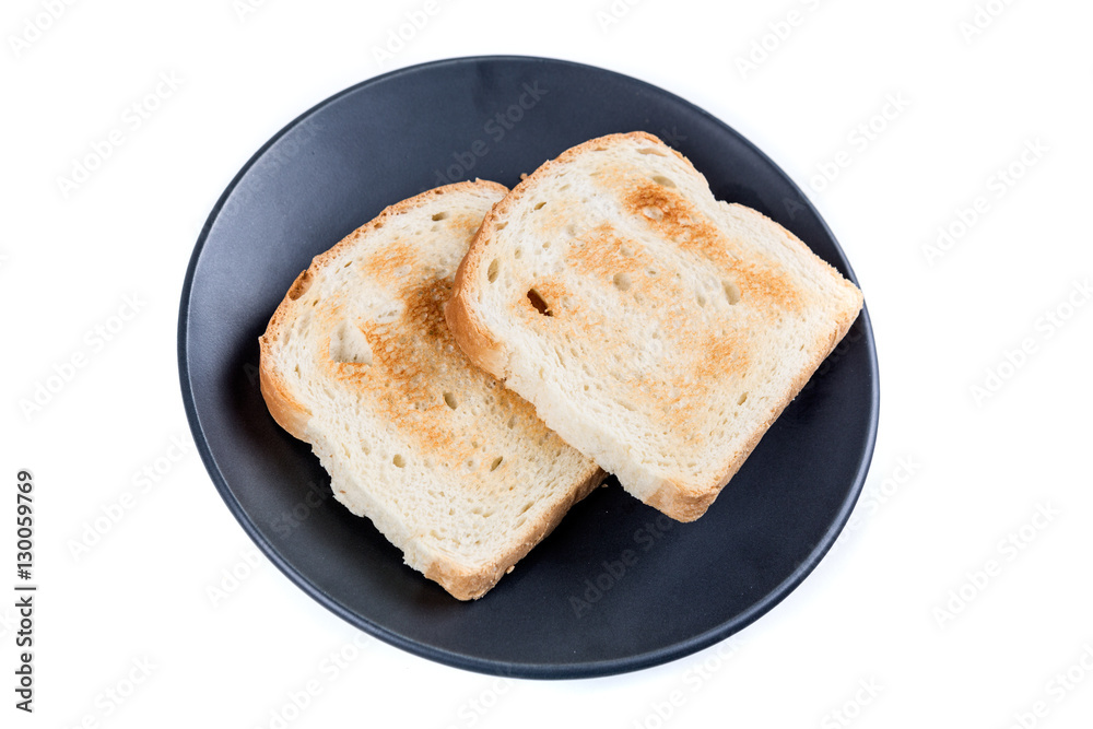 Two whole grain slices of bread toasted on a ceramic plate isolated on white background Two whole grain slices of bread toasted on a ceramic plate isolated on white background