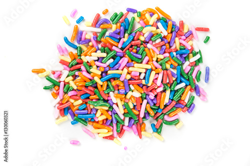 Assorted rainbow colored sprinkles isolated on white background