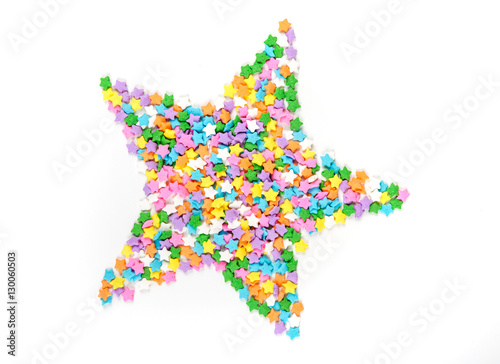 Star shaped assorted rainbow colored sprinkles isolated on white background
