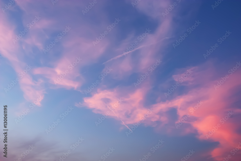 Beautiful dramatic Twilight sky and clouds with long line of jet engine clouds.