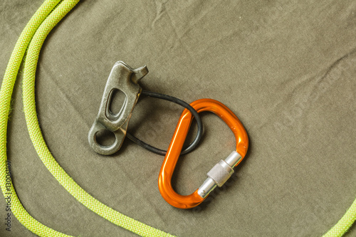 Belay device, D-shaped carabiner and rope.