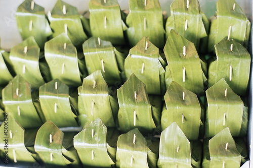 Food wrapped in banana leaf at open air market, Bangkok photo