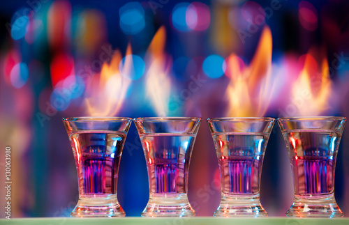 Sticker Four hot shot glasses on a bar counter