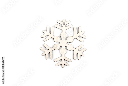 Gorgeous white wooden decoration - snowflake/ star. Adorable winter, Christmas, New Year, event decor made from solid wood. Isolated on white background. Top view. Closeup.