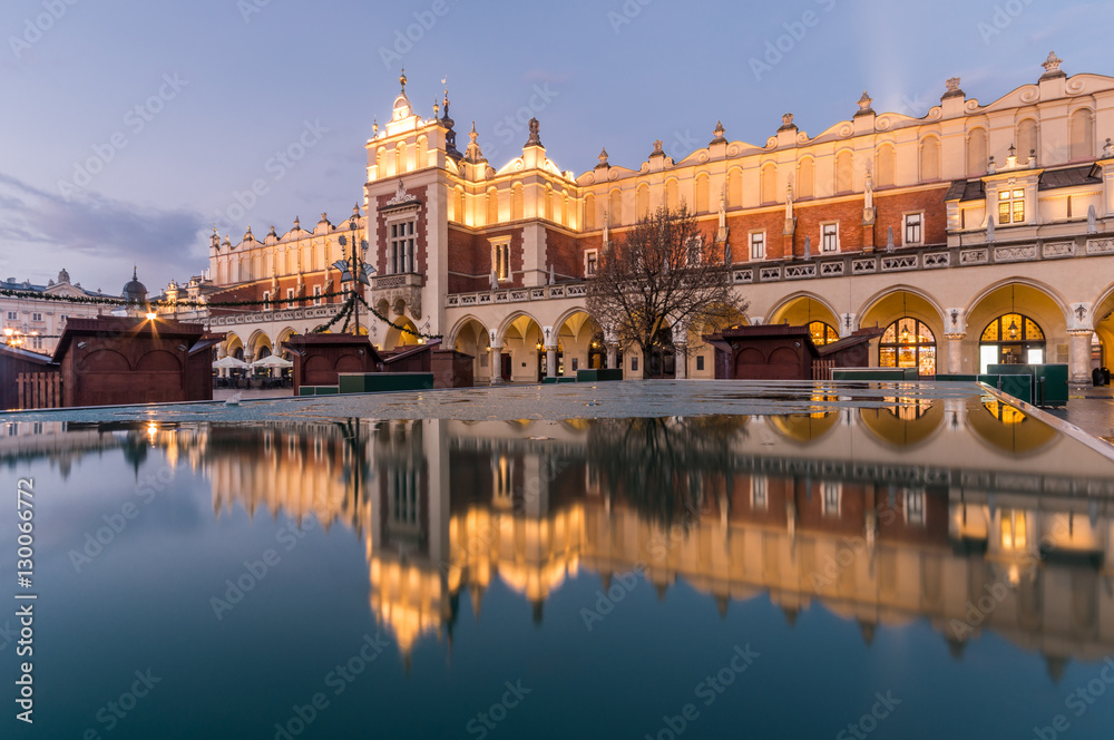 Krakow, Poland, Cloth Hall in the night, reflecting in the puddle