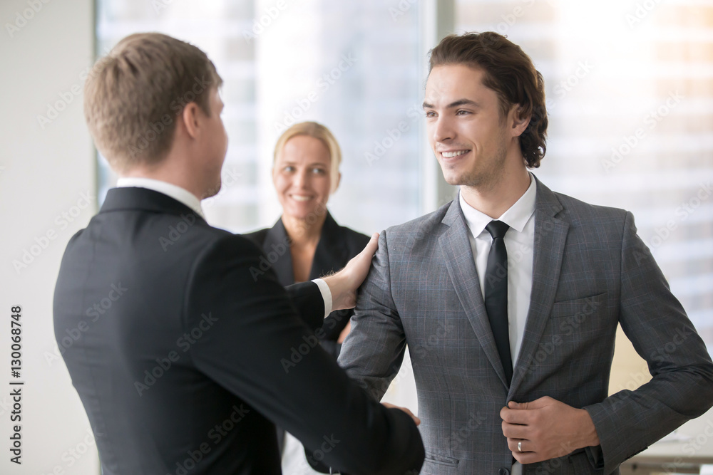 Two smiling businessmen handshaking Two smiling businessmen handshaking