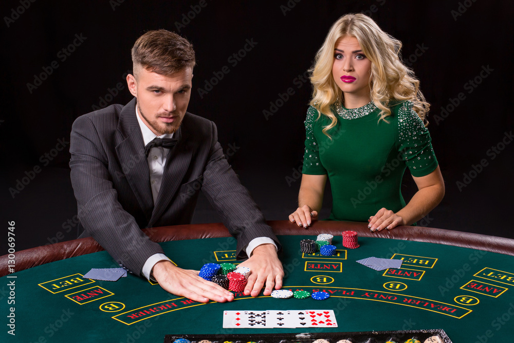 © nazarovsergey - couple playing poker at the table.