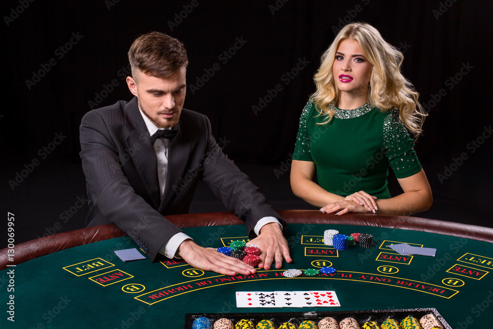 couple playing poker at the table. couple playing poker at the table.