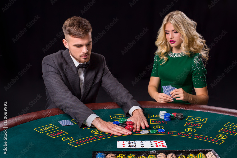 couple playing poker at the table. couple playing poker at the table.