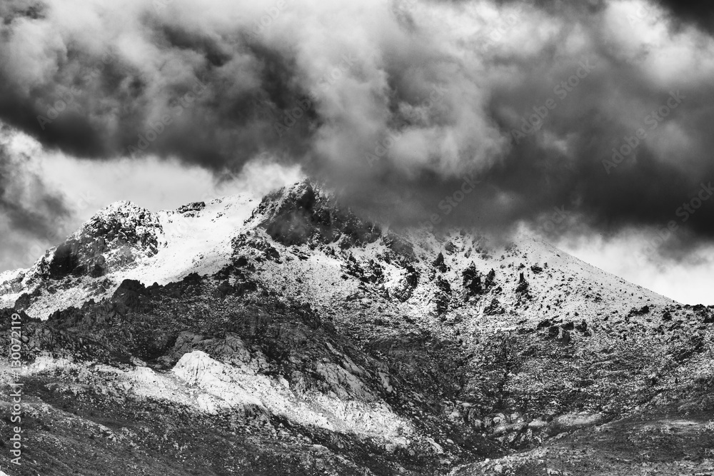Black and white of Beautiful snow-capped mountains against dramatic clouds, Guadarrama mountain range, Madrid, Spain. 