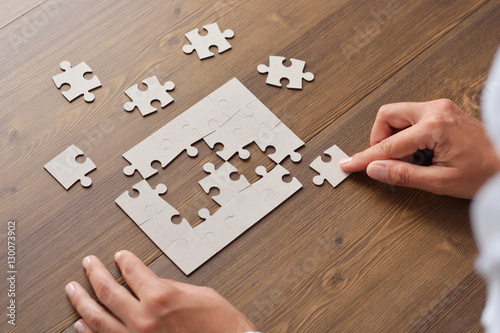 Folding puzzle hand parts on a wooden table