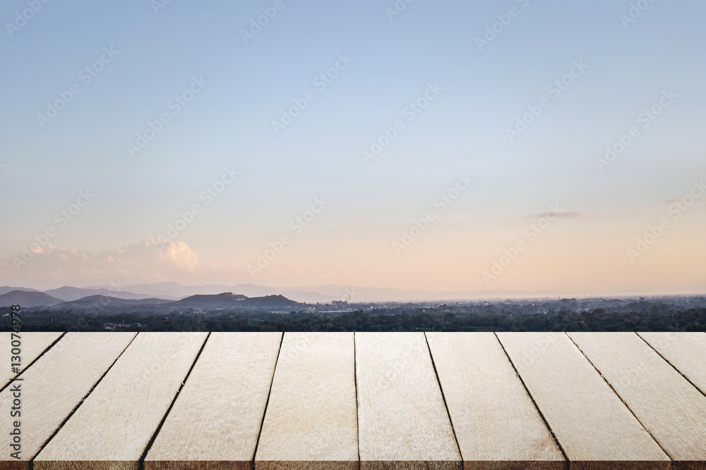 Empty tabletop over outdoor landscape sunset vintage sky backgro