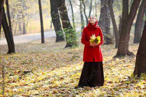 Beautiful young girl walking in autumn park. © Vitalfoto