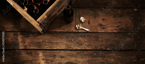 Beer bottles in a crate in a rustic pub or tavern photo