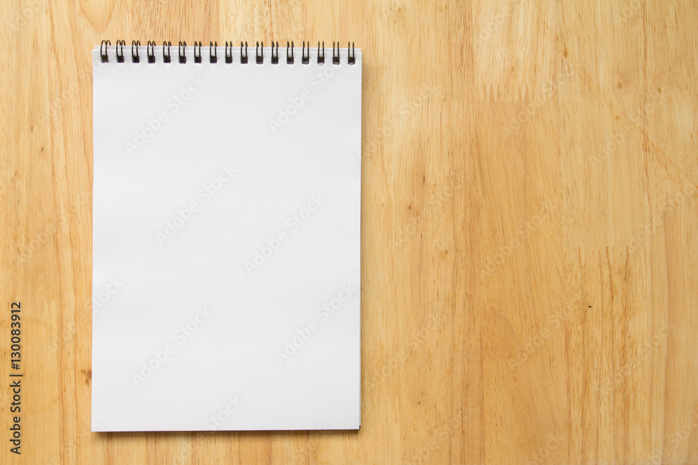 Blank paper note book on wood table background Blank paper note book on wood table background