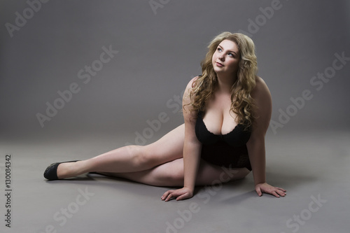 Young beautiful blonde plus size model with big natural breasts in  underwear, xxl woman on gray studio background Stock Photo by ©starast  133876770