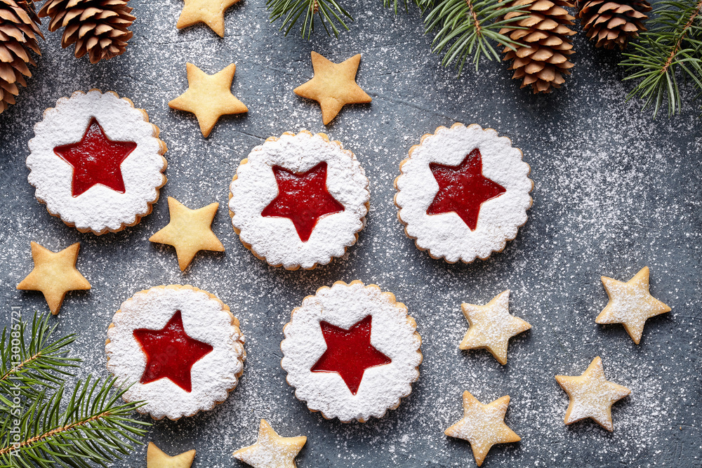 Jelly Christmas Linzer cookies star with jam. Homemade ginger cakes on green background. Shortcrust pastry. Top view. Flat lay. Festive decoration.
