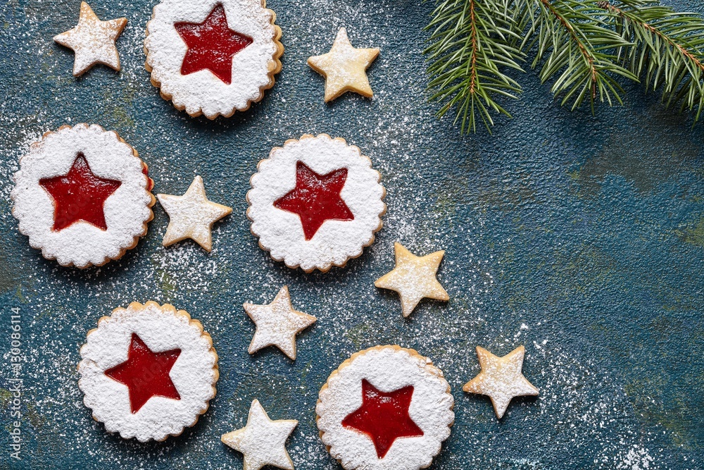Christmas or New Year homemade cookies star with strawberry jam. Traditional Austrian dessert - Linzer biscuits. Flat lay. Festive decoration. Top view. Copy space. Christmas or New Year homemade cookies star with strawberry jam. Traditional Austrian dessert - Linzer biscuits. Flat lay. Festive decoration. Top view. Copy space.