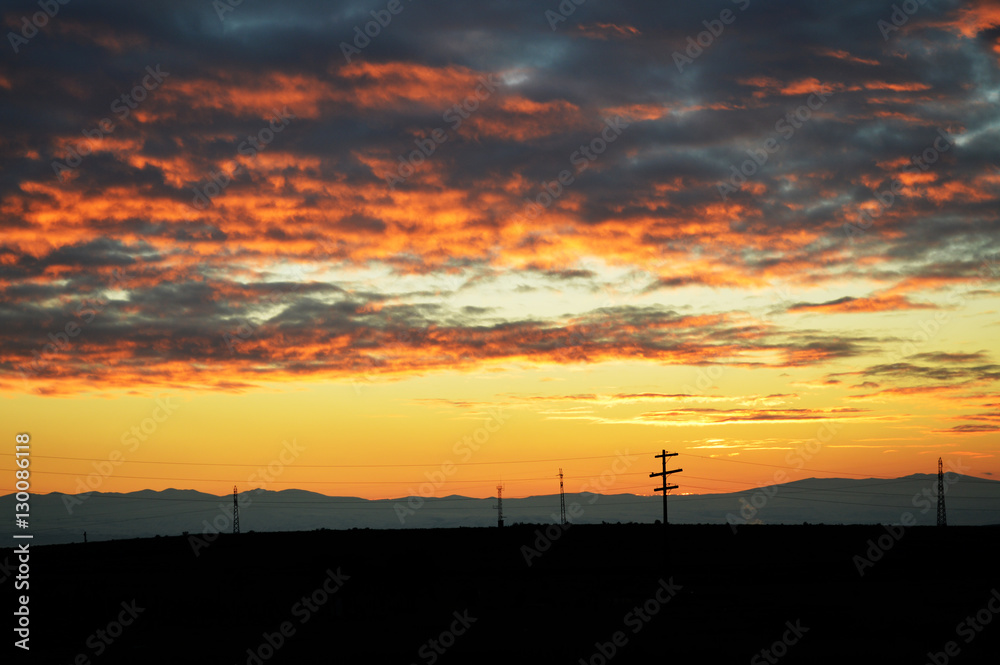 Dramatic sunset sky with mountain silhouettes