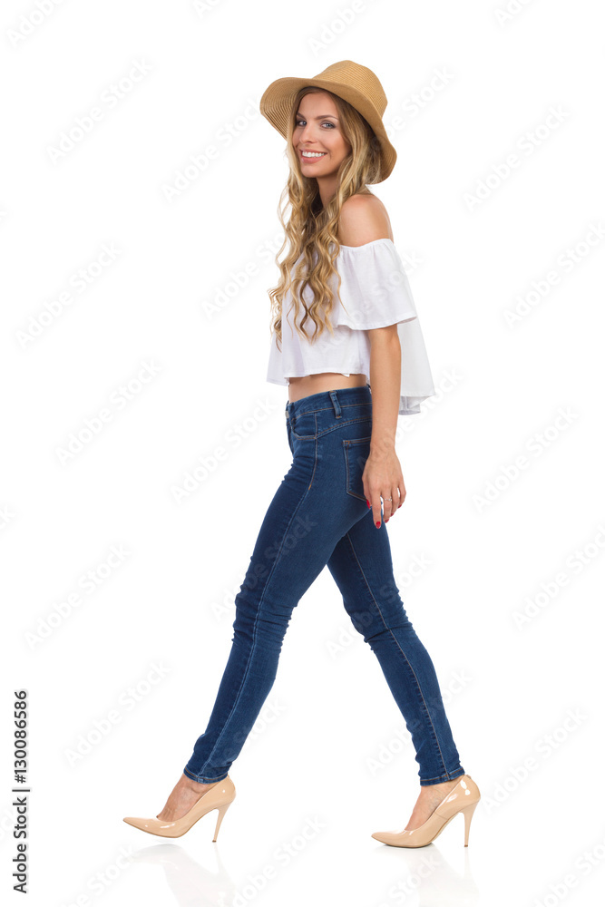 Walking Woman In Jeans, High Heels And Straw Hat Walking Woman In Jeans, High Heels And Straw Hat
