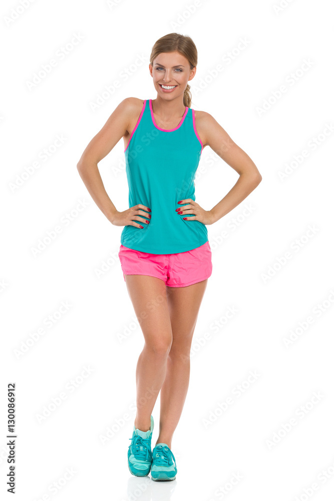 Woman In Vibrant Clothes Posing With Hands On Hip Woman In Vibrant Clothes Posing With Hands On Hip