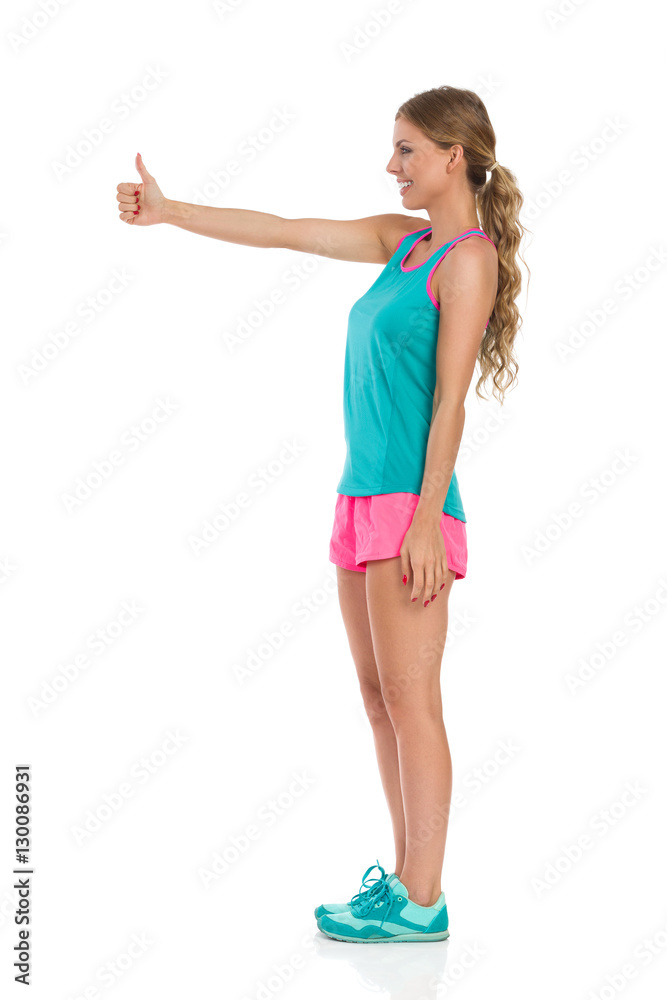 Woman In Vibrant Sports Clothes Gives Like Woman In Vibrant Sports Clothes Gives Like