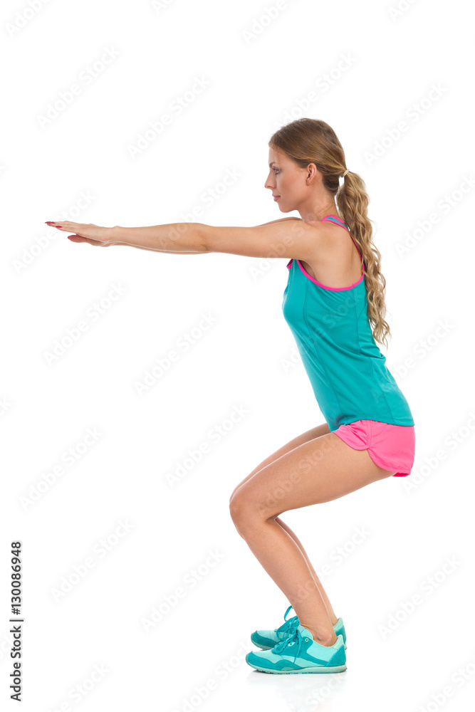 Woman Does A Squat. Side View