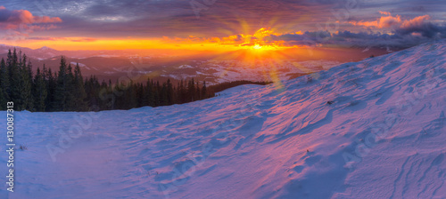 Majestic colorful sunrise in mountains with colored clouds and p