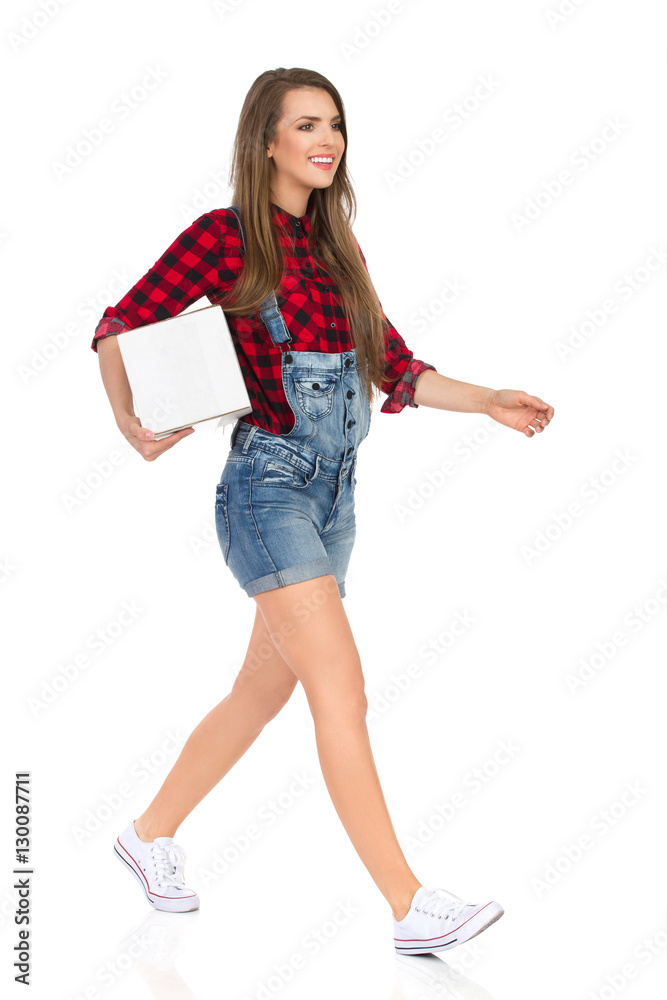 Smiling Woman Worker Walking With White Box Under Arm Smiling Woman Worker Walking With White Box Under Arm