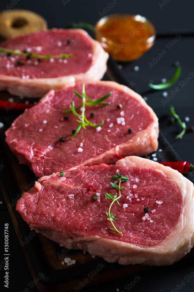 Raw steaks and spices Raw steaks and spices