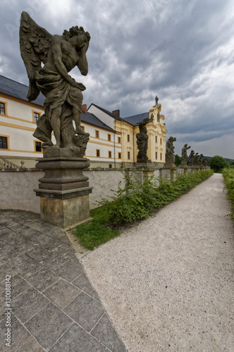 Perspective shot of a statue in the forefront of a palace