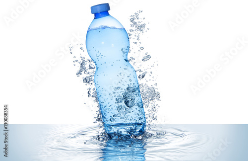  blue water bottle and bubbles above rippled wave isolated on white