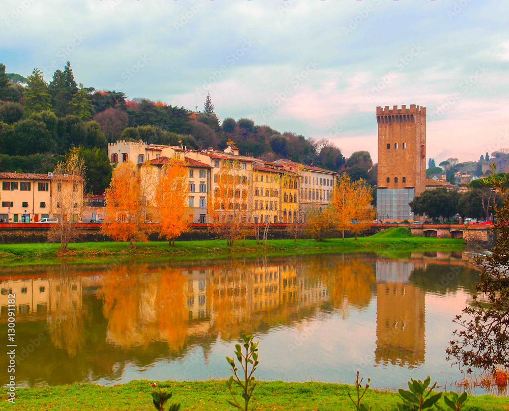 Autumn in Italy. Old town with red stone building by the natural lake