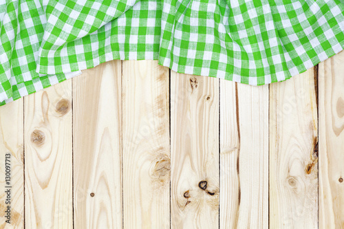Wooden table, top view, green checkered tablecloth