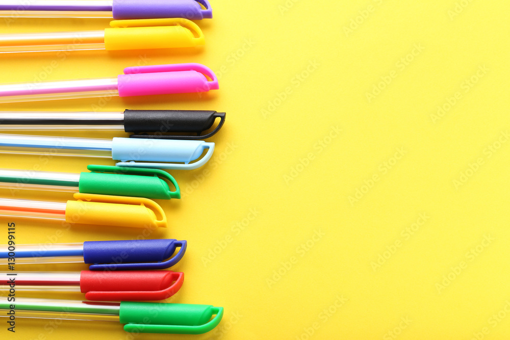 Colored pens on a yellow background Colored pens on a yellow background