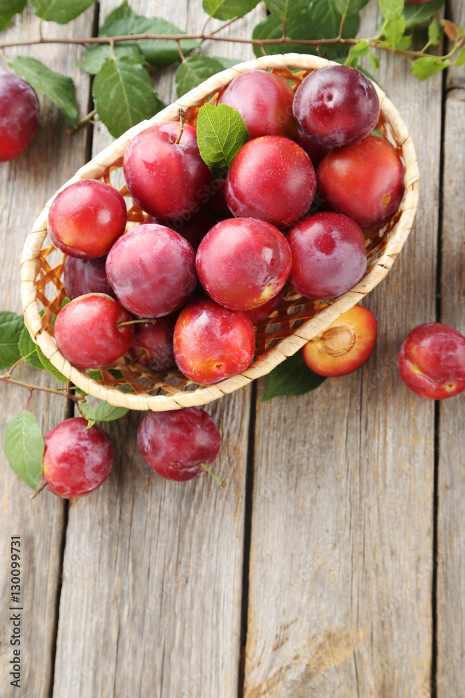Fresh plums on a grey wooden table Fresh plums on a grey wooden table