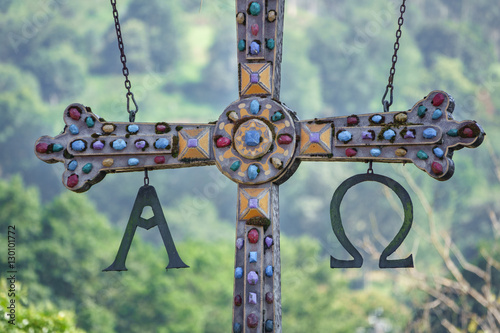Detail on hanging cross in roman bridge of Cangas de Onis photo