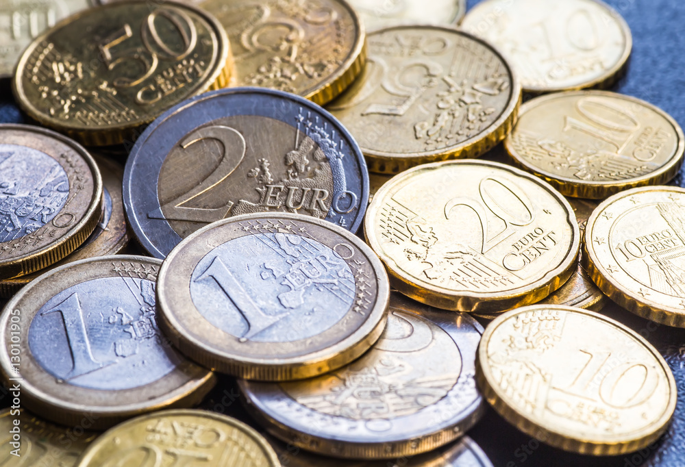 Euro coins. One Euro coin on the foreground. Euro coins. One Euro coin on the foreground.