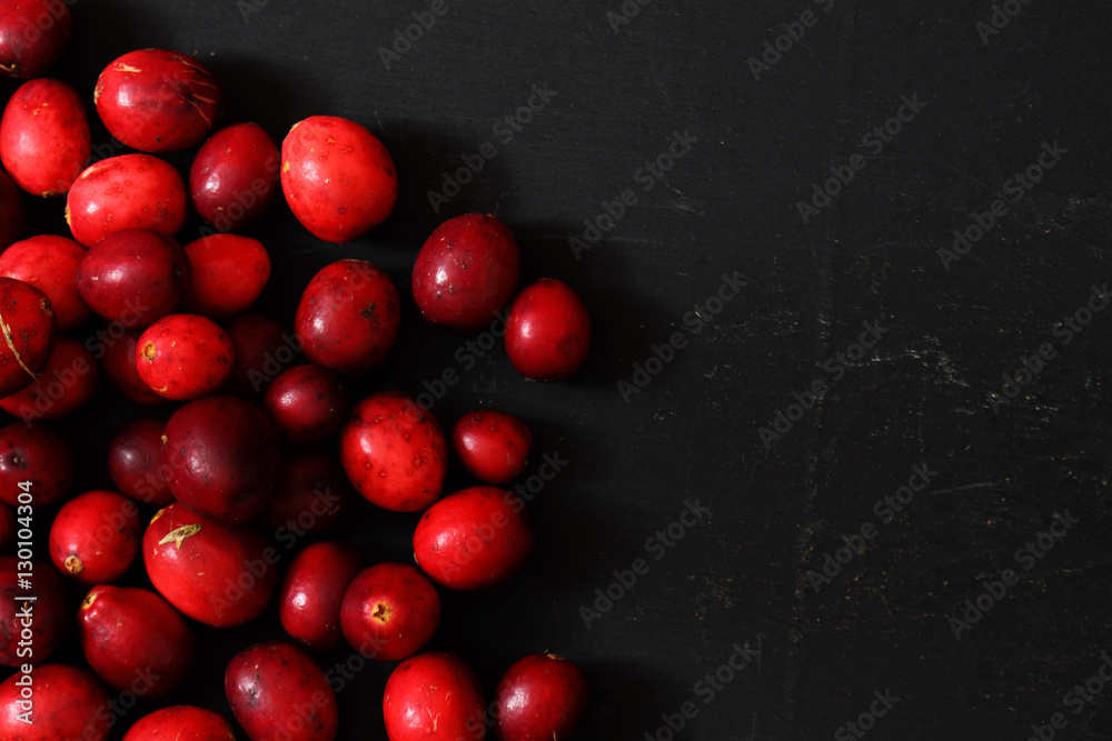 Cranberries on a black wood background Cranberries on a black wood background