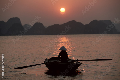 Woman rowing woven skiff, Ha Long Bay (Ha-Long Bay), Vietnam 