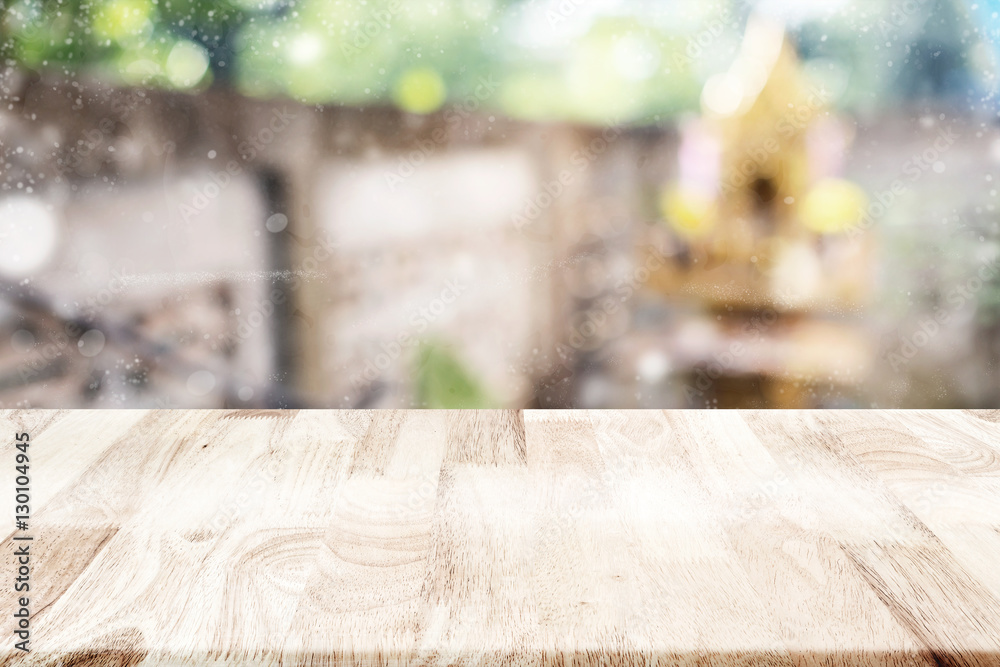 Empty wooden tabletop over blurry building with concrete and fak Empty wooden tabletop over blurry building with concrete and fak