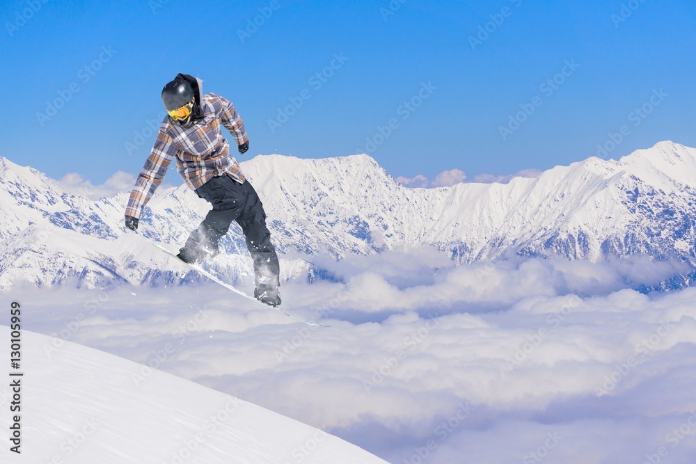 Snowboard rider jumping on mountains. Extreme sport.