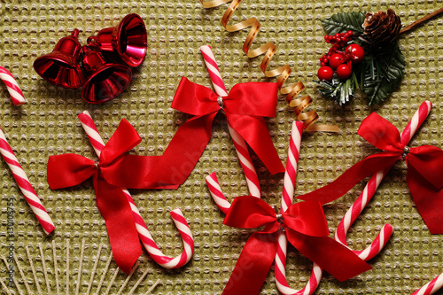 Christmas still life with red bows, candy, ribbons and other beautiful scenery.