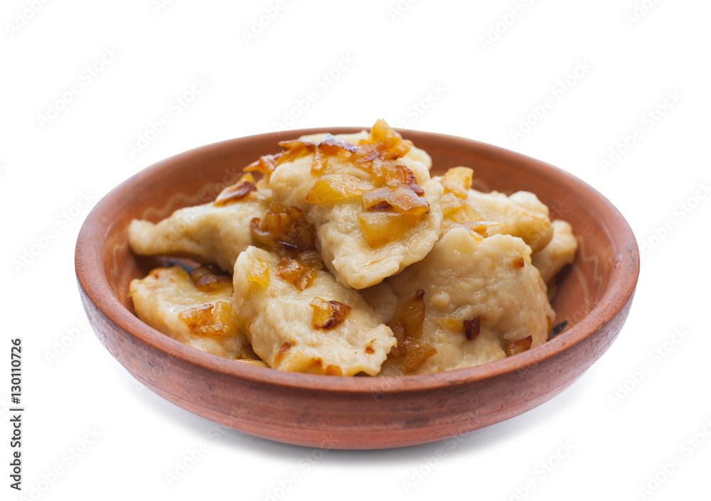 Cooked dishes of national Ukrainian dumplings with onion kitchen- lie in a clay plate. Cooked dishes of national Ukrainian dumplings with onion kitchen- lie in a clay plate.