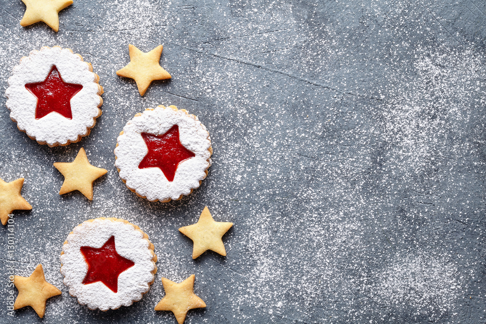 Linzer star cookies with jam filling flat lay traditional Christmas homemade winter Austrian sweet dessert food Xmas celebration pastry powdered holiday snack on vintage table background. Linzer star cookies with jam filling flat lay traditional Christmas homemade winter Austrian sweet dessert food Xmas celebration pastry powdered holiday snack on vintage table background.
